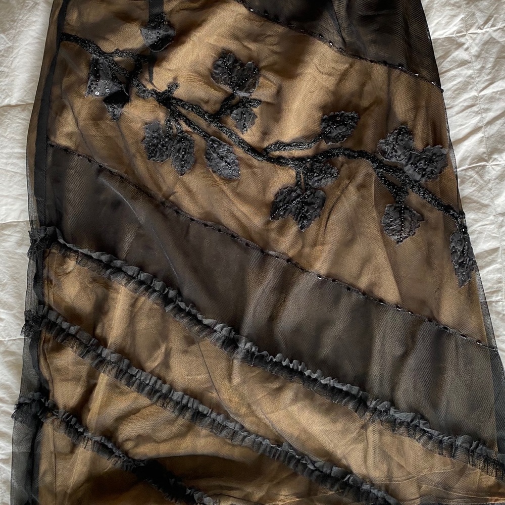 Gold skirt with black sheer overlay with designs